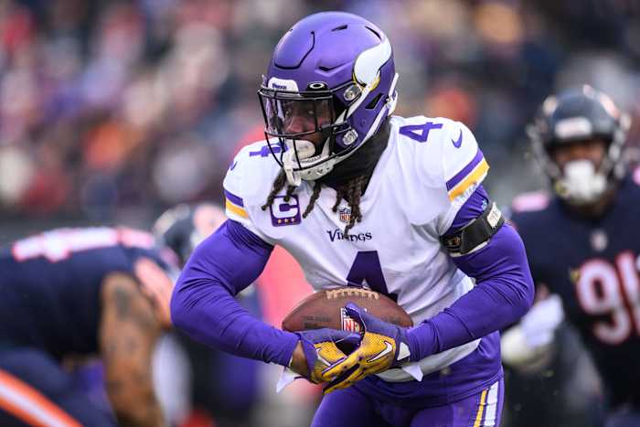 Dalvin Cook runs with the ball held in two hands